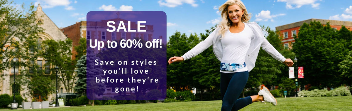 Delighted woman skipping in grass wearing a blue and white BANDI Belt with text highlighting the SALE page