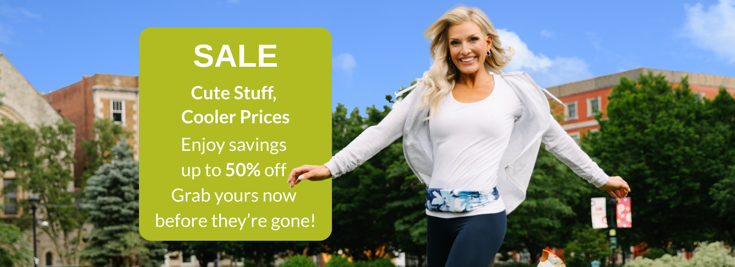 Delighted woman skipping in grass wearing a blue and white BANDI Belt with text highlighting the SALE page