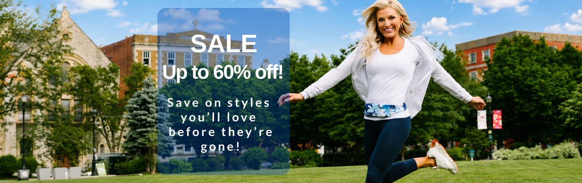 Delighted woman skipping in grass wearing a blue and white BANDI Belt with text highlighting the SALE page