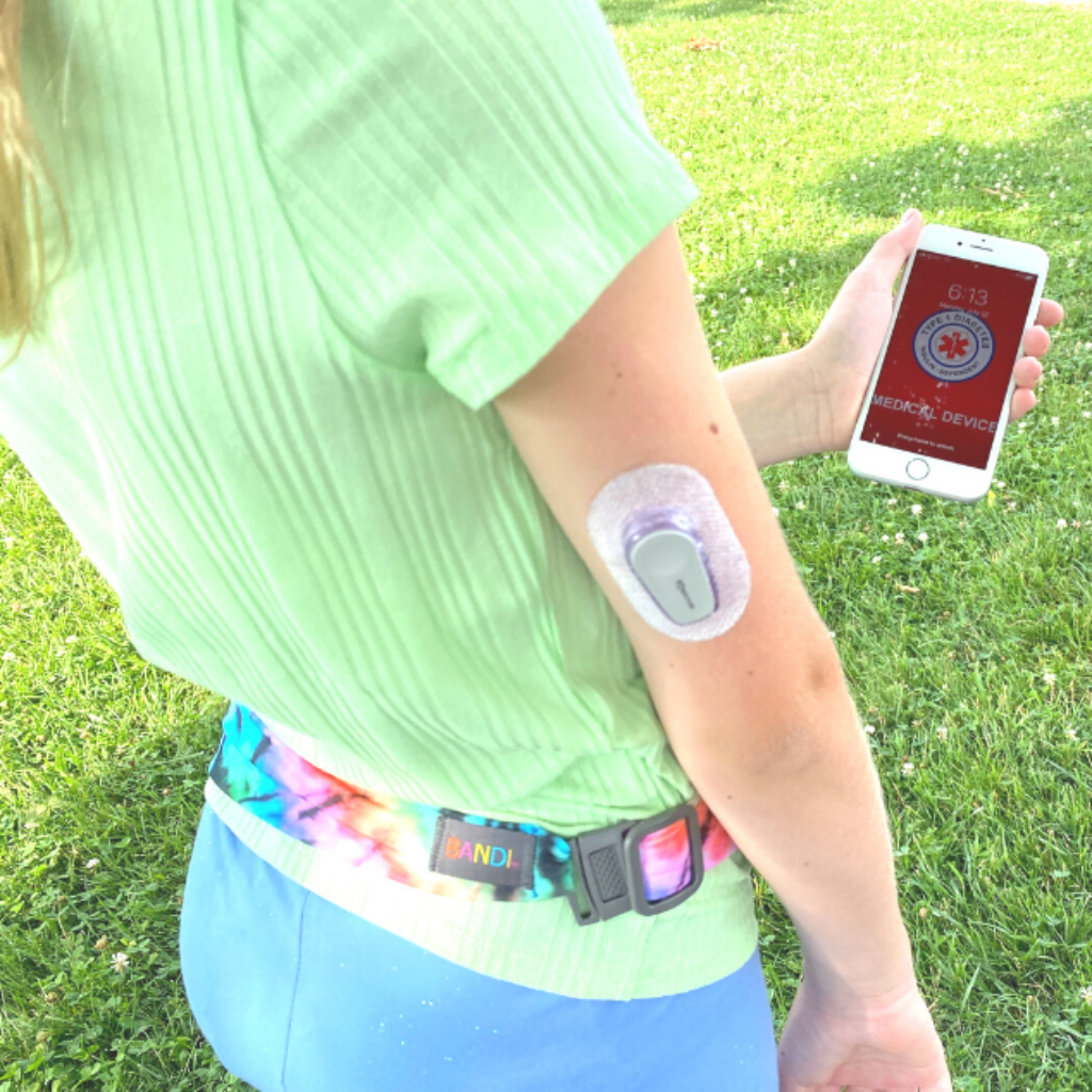 Girl with medical alert on phone and wearing BANDI Pocketed Belt