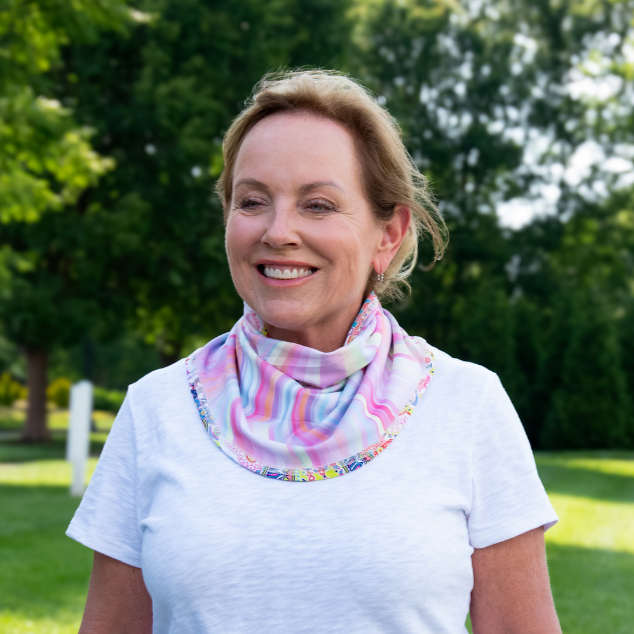 woman wearing BANDI Sun Wrap on the reverse side. Colors are swirls of pink and blue pastels