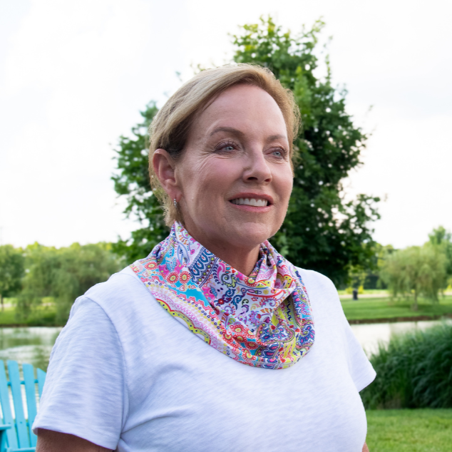 Woman wearing BANDI Paisley Carousel bandana Sun Wrap with white t-shirt.