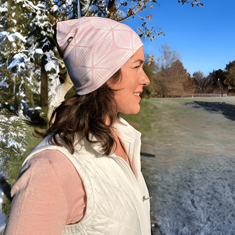 Woman wearing Snow Petal cozy wrap as a Beanie cap.