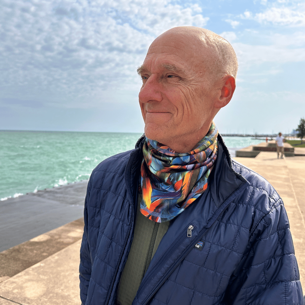 Man wearing Plumes cozy wrap around neck.