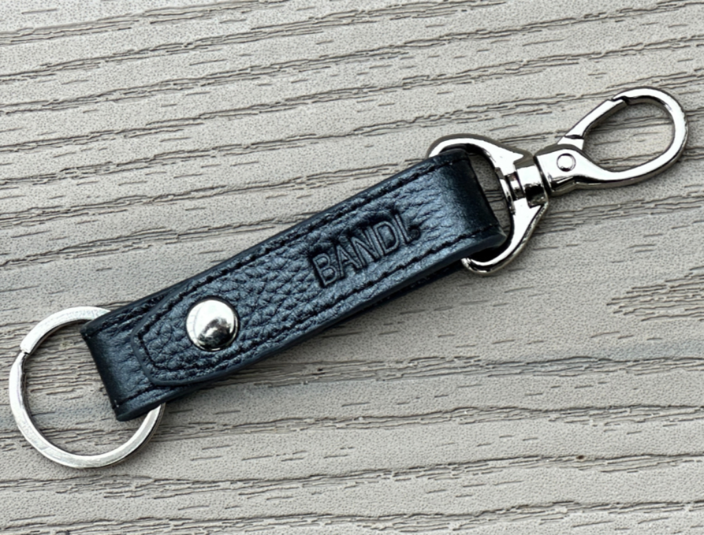 Black BANDI Keychain shown laying flat