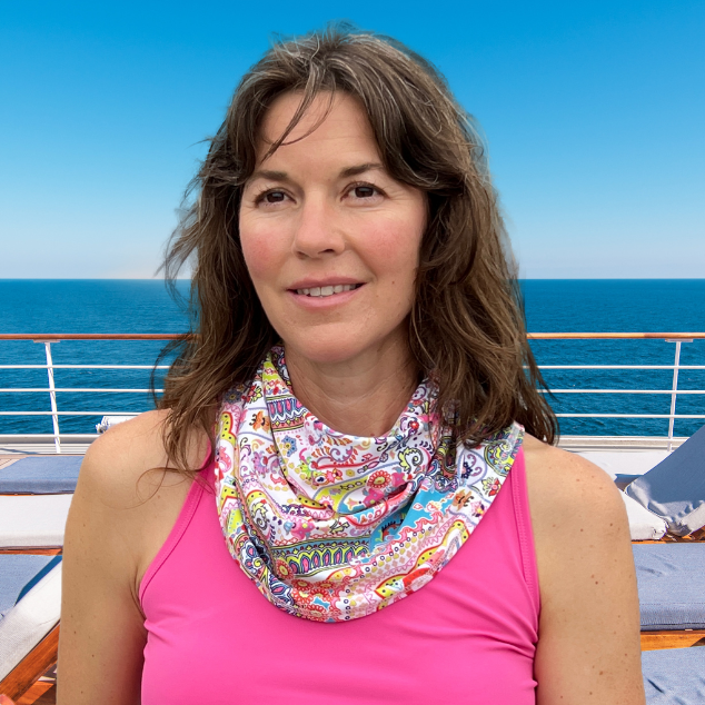 woman on deck of cruise ship wearing pink top and BANDI Paisley print Sun Wrap