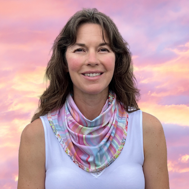 Woman with white top and BANDI Sun Wrap with pin sky in background