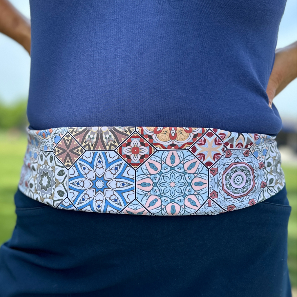 close up of Harmony Pocketed Belt on body in tones of blue pink red and ivory