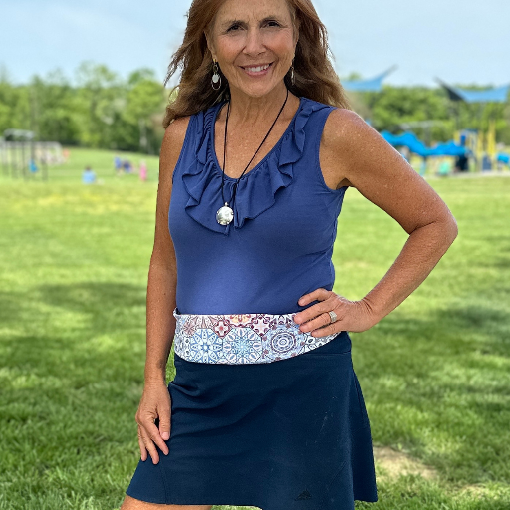 Woman wearing Harmony Pocketed Belt by BANDI with blue top and navy skort