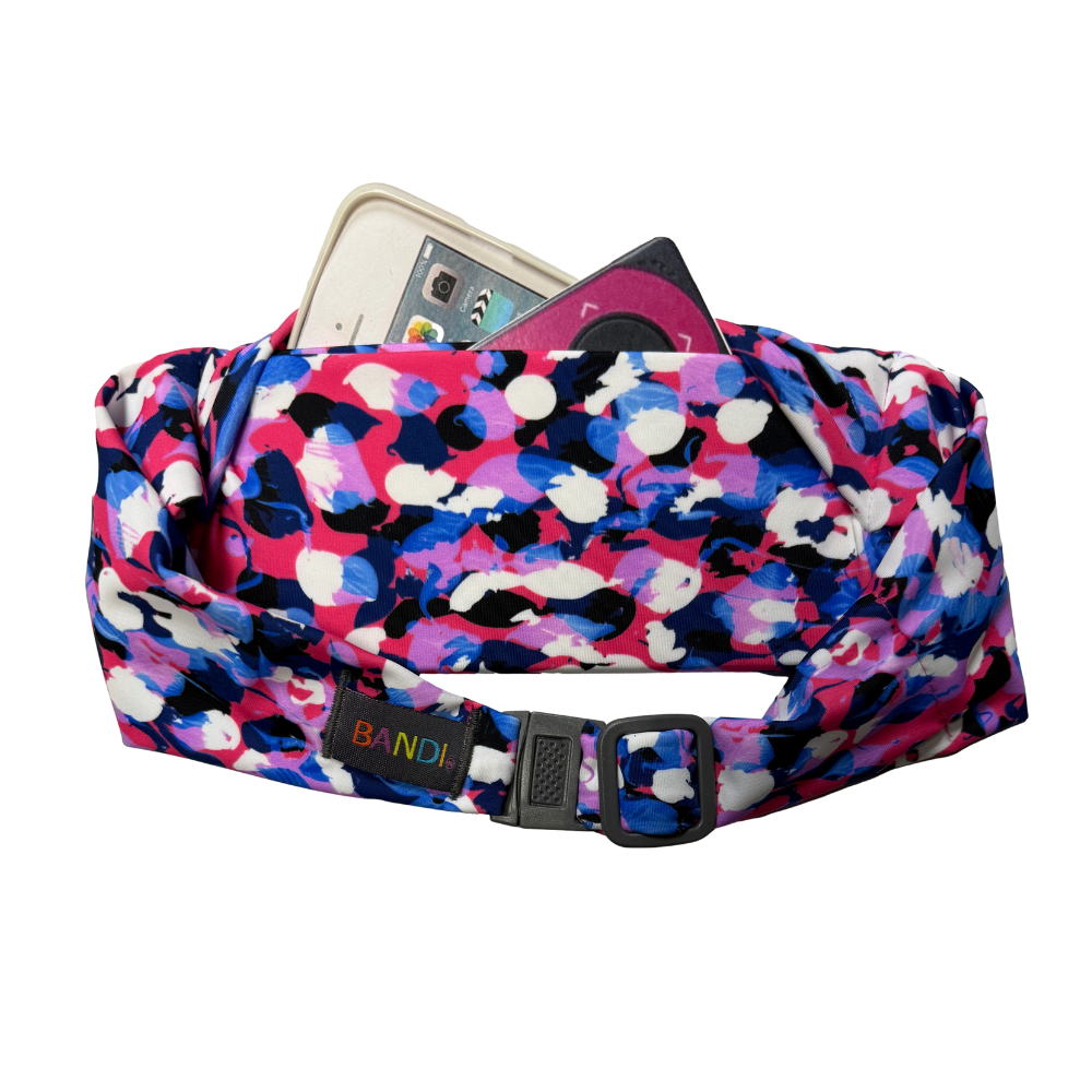 Colorful patterned kids waist bag with phone and items on a white background
