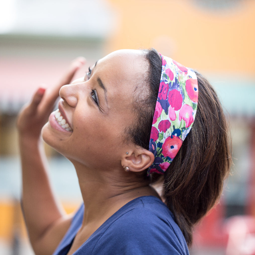 Woman smiling and waving wearing BANDI Poppies headband