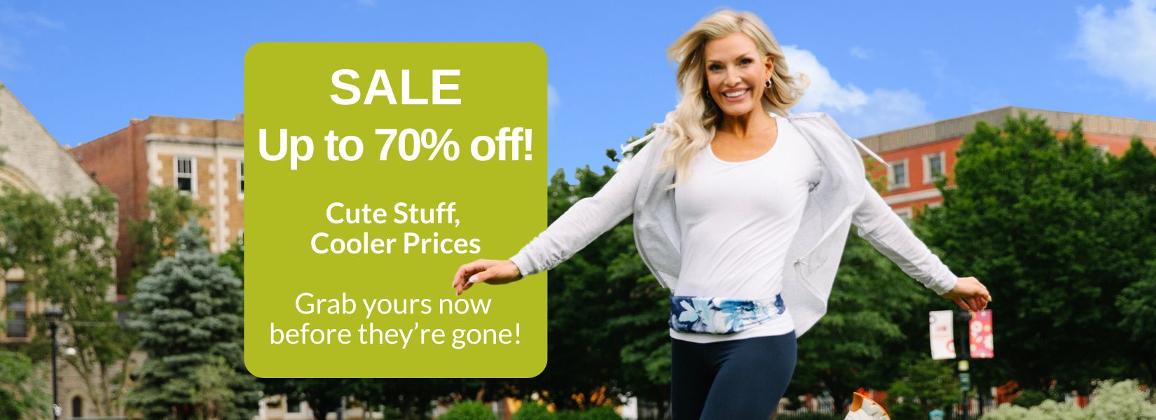Delighted woman skipping in grass wearing a blue and white BANDI Belt with text highlighting the SALE page