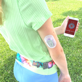 Girl with medical alert on phone and wearing BANDI Pocketed Belt