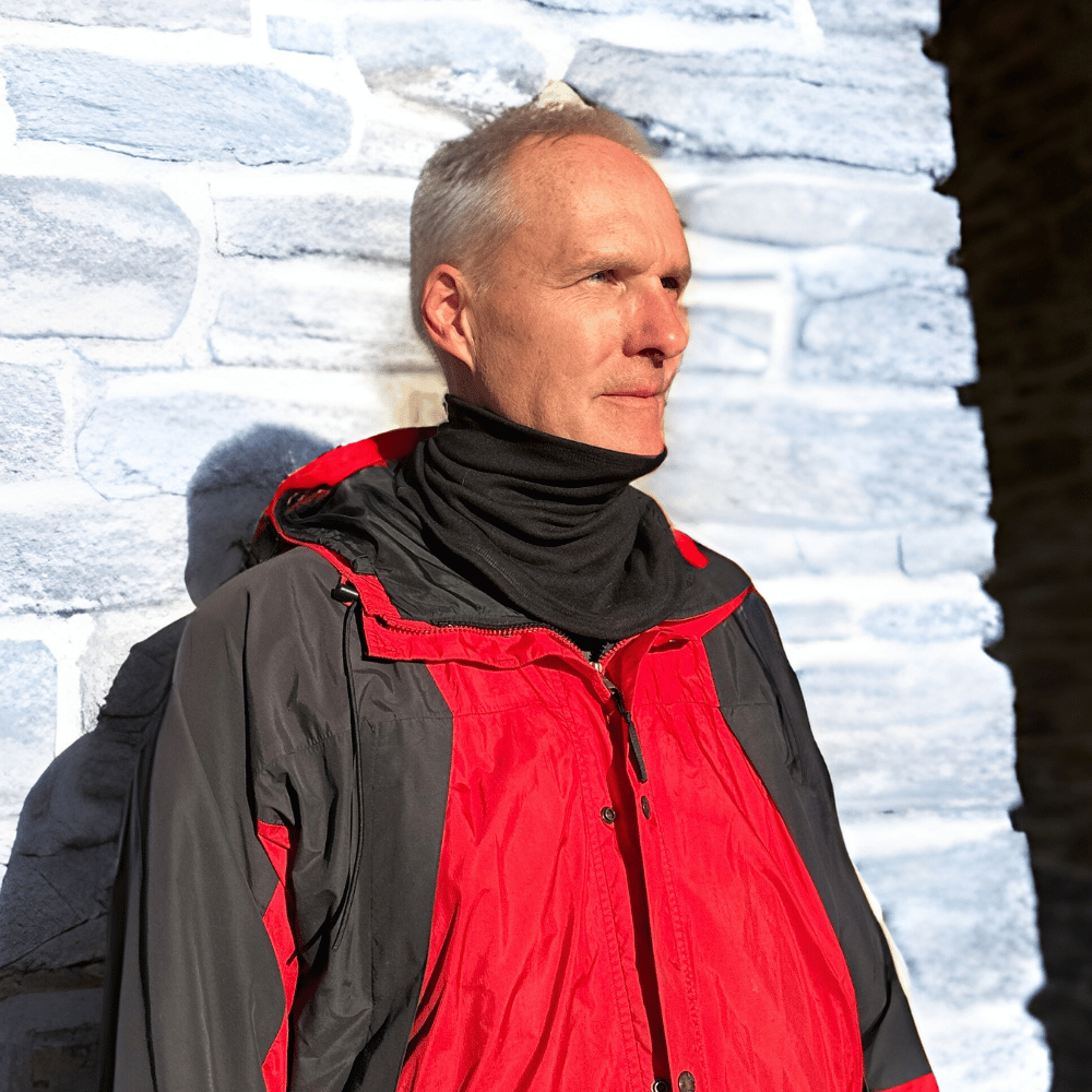 Man wearing Black Cozy Wrap around neck.