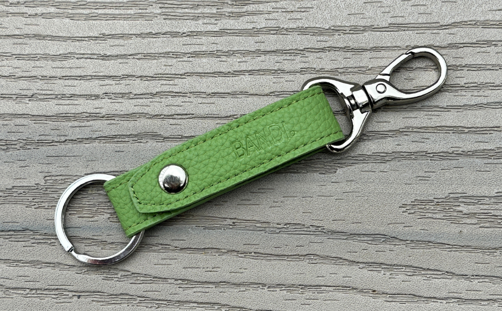 BANDI Key chain in faux leather.  Kiwi green strap with fixed key ring and removable clip.