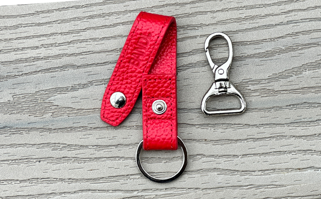 BANDI Wear Leather strap key chain in cherry red with ring on one side and detachable clip on the other.