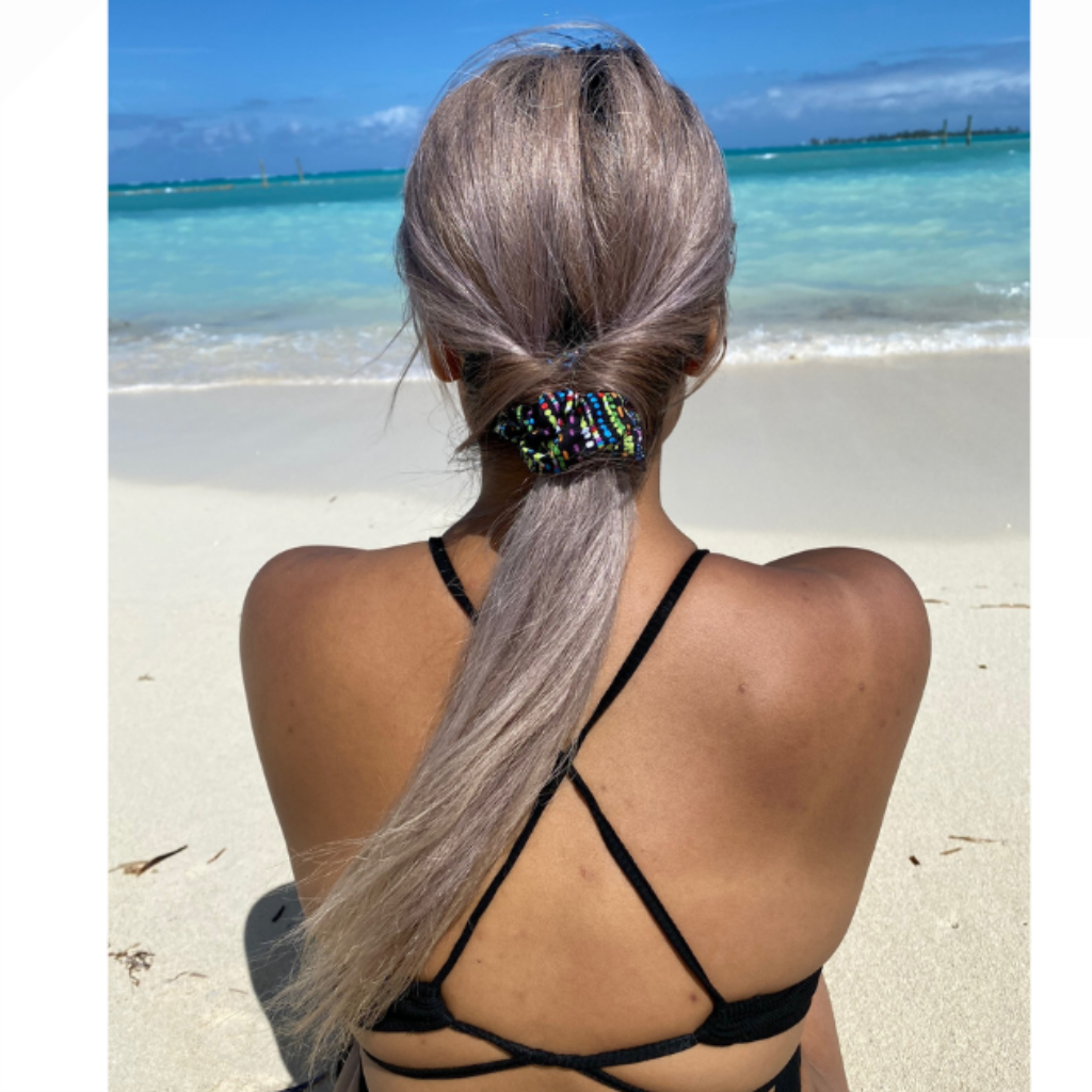 woman at beach wearing BANDIWear scrunchie